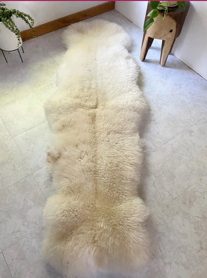 Beige sheepskin rug made of two hides with long pile