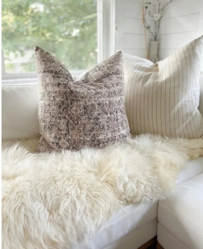 Beige sheepskin rug made of two hides with long pile