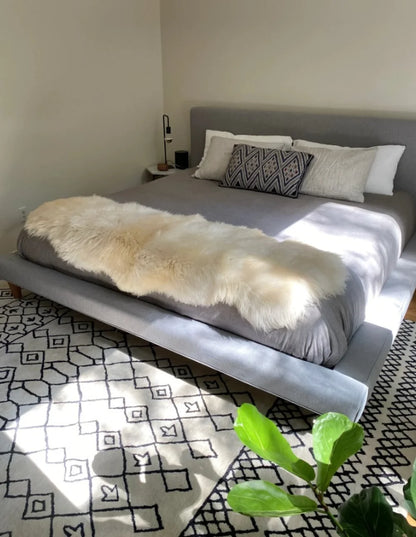 Beige sheepskin rug made of two hides with long pile