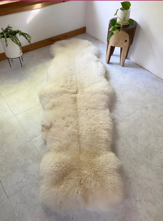 Beige sheepskin rug made of two hides with long pile