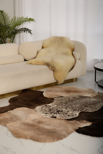 The Mossi rug is crafted from six natural sheepskins in deep brown tones.