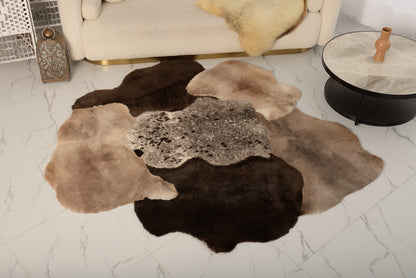 The Mossi rug is crafted from six natural sheepskins in deep brown tones.