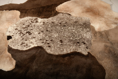 The Mossi rug is crafted from six natural sheepskins in deep brown tones.