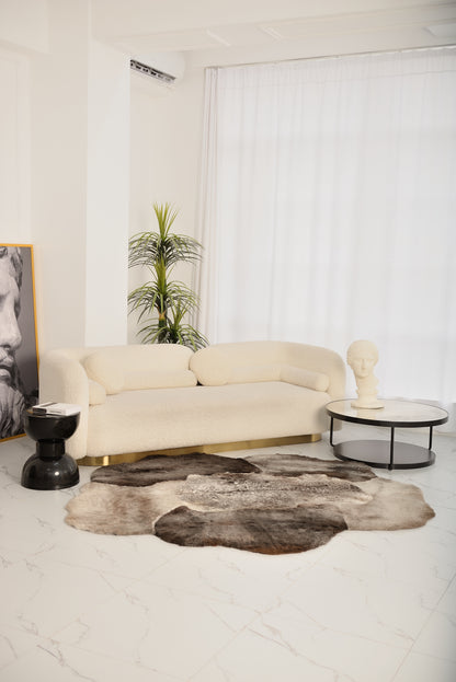 The Mossi rug in light gray is crafted from six genuine sheepskins