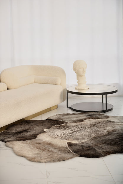 The Mossi rug in light gray is crafted from six genuine sheepskins