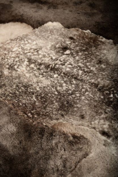 The Mossi rug in light gray is crafted from six genuine sheepskins