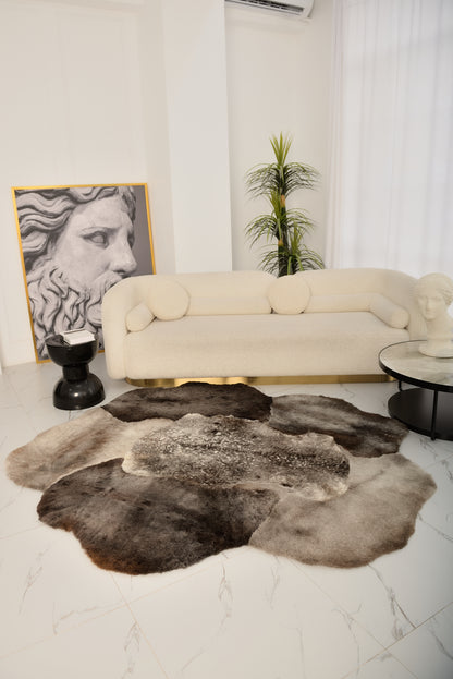The Mossi rug in light gray is crafted from six genuine sheepskins